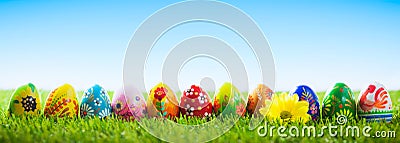 Colorful hand painted Easter eggs on grass. Banner, panoramic Stock Photo