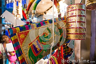 Colorful handbags, bangles, accessories, and decoration items hanging in a shop Editorial Stock Photo