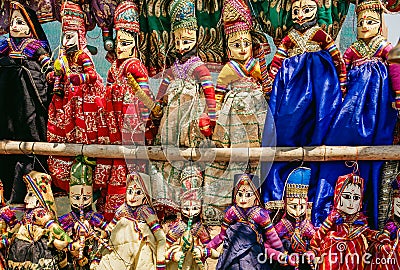 Colorful handcrafted dolls in traditional costumes of India. Marketplace with old style indian toys for children Stock Photo