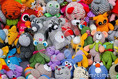 Colorful handmade knitted dolls. Hobby & small business of women. Closeup. Showcase at the fair Stock Photo