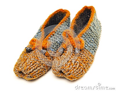 Colorful handmade knitted wool slippers stand on a white background Stock Photo