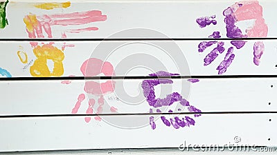 Colorful handprints on wooden planks Stock Photo