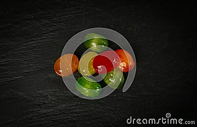 Colorful Hard Candies Pile on Black Texture Background Stock Photo