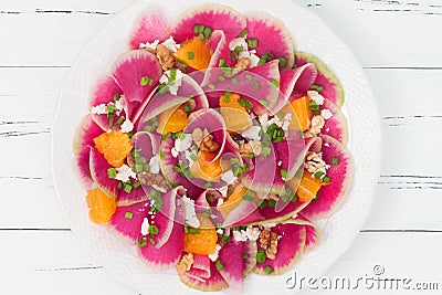Colorful and healthy watermelon radish, orange and goat cheese carpaccio salad. Top view, free text copy space Stock Photo