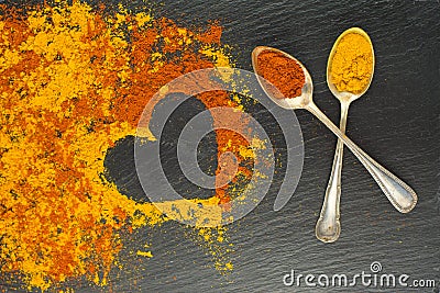Colorful heart from spices with two vintage spoons on black background with two vintage spoons. Selective focus. Valentines day. Stock Photo