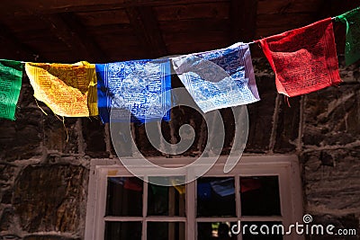 Colorful Himalayan prayer flags on a mountain hut Stock Photo