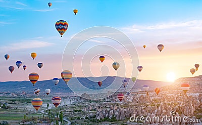 Colorful hot air balloons flying over rock landscape at Cappadocia Turkey Stock Photo