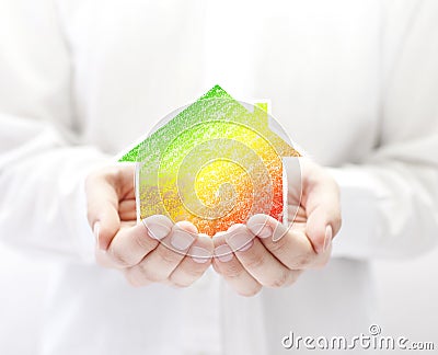 Colorful house in hands. Energy saving concept. Stock Photo