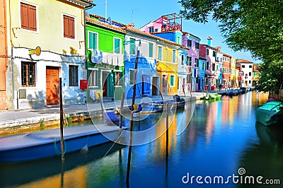 Colorful houses along a canal embankment on Burano island Stock Photo