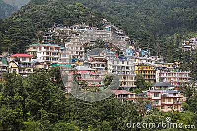 Colorful houses and a green pine forest in Himalaya mountains in Dharamsala, India Editorial Stock Photo