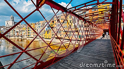 Colorful houses seen through the red iron bridge in Girona, Catalonia, Spain Editorial Stock Photo