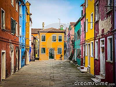 Colorful houses on a small traditional square at Burano island, Venice Editorial Stock Photo