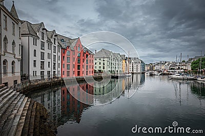 Colorful houses and waterway with boats in the city Alesund in Norway Editorial Stock Photo