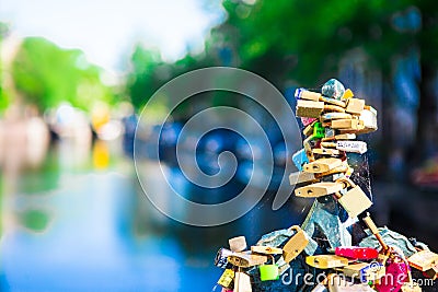 Colorful hundreds of padlocks-love locks on canal in Amsterdam, Netherlands Editorial Stock Photo