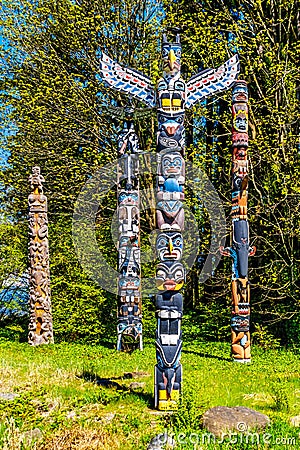 Colorful indigenous Totem Poles located in Stanley Park in Editorial Stock Photo