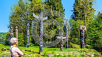 Colorful indigenous Totem Poles in Stanley Park in Editorial Stock Photo