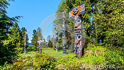 Colorful indigenous Totem Poles in Stanley Park in Editorial Stock Photo