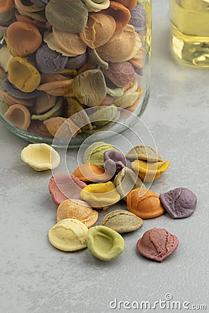 Colorful Italian raw Orecchiette Arcobaleno pasta in a glass bowl Stock Photo