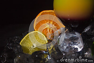 Colorful juice cocktail with straw on the black background. Stock Photo