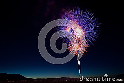 Colorful July 4th Fireworks Celebration at Twilight Stock Photo