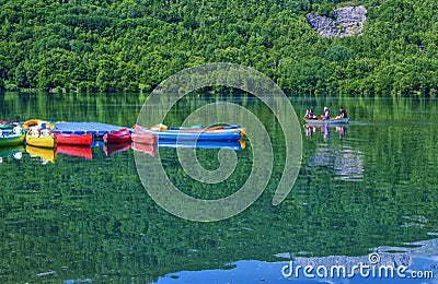 Colorful kayak boats resting on the lake in a nautical school about to slip from Huesca Spain Editorial Stock Photo