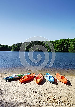 Colorful kayaks on the shore of Lake Johnson, a popular city park in Raleigh NC Stock Photo