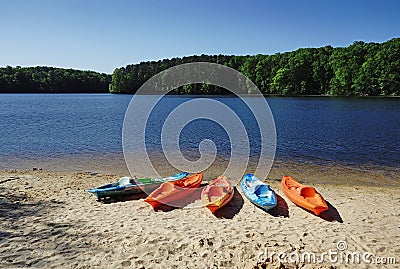 Colorful kayaks on the shore of Lake Johnson, a popular city park in Raleigh NC Stock Photo