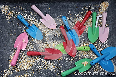 Colorful Kids shovels in a playground sandbox Stock Photo