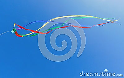 Colorful kite soars across a blue sky Stock Photo