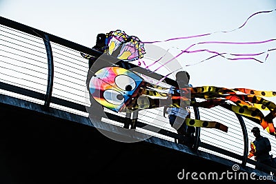 Colorful kites silhouetted against a blue sky Editorial Stock Photo