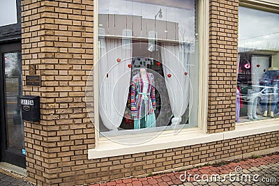 A colorful knitted coast surrounded by hearts on a street in a store of clothing store in Douglasville Georgia Editorial Stock Photo