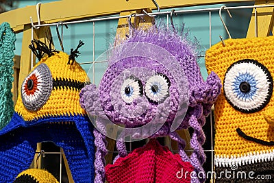 Colorful knitted handmade toys are on display for sale at a souvenir shop Editorial Stock Photo