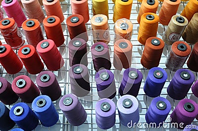 Colorful knitted thread spools put on a shelf at a shop Editorial Stock Photo