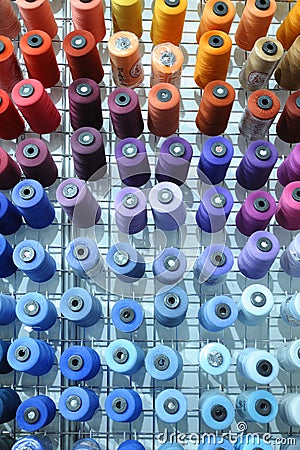 Colorful knitted thread spools put on a shelf at a shop Editorial Stock Photo