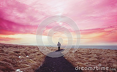 Colorful landscaped, a man walking alone on the way forward with colorful sky Stock Photo