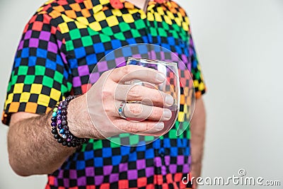 Colorful lgbt caucasian male holding wine stemless glass, white background Stock Photo