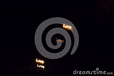 Colorful love lettering bokeh on a dark background, yellow love lettering bokeh Stock Photo