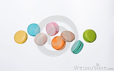 Colorful macarons cakes. Sweet french macaroons flying in motion Stock Photo