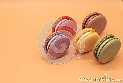 Colorful macaroons cakes on orange background Stock Photo