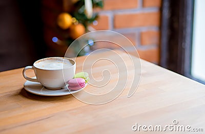 Colorful macaroons and coffee cup on window background Stock Photo