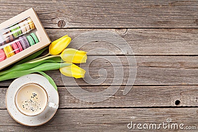 Colorful macaroons, coffee cup and yellow tulips Stock Photo