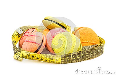 Colorful macaroons with measuring tape on white Stock Photo