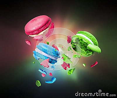 Colorful macaroons is torn to pieces in the dark Stock Photo