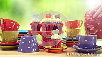 Colorful Mad Hatter style tea party with cupcakes Stock Photo