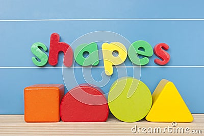Colorful magnetic letter spelling shapes. Stock Photo