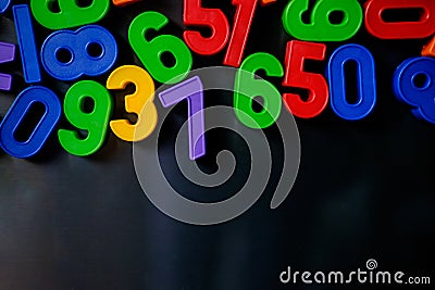 Colorful magnetic numbers and letters on the fridge Stock Photo