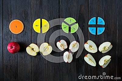 Colorful math fractions on brown wooden background or table. interesting math for kids. Education, back to school concept. Stock Photo