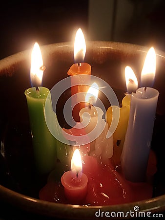 Colorful melted tapir candles in a bowl ritual or relaxation meditation style Stock Photo