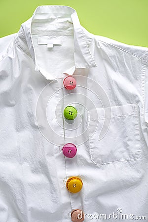 Colorful mini macarons on white shirt imitating buttons Stock Photo