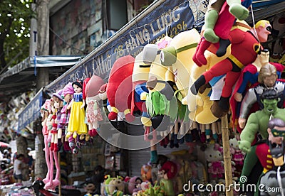 Colorful minions and superman puppets hanging for sale at an old street in Hanoi quarter streets Editorial Stock Photo